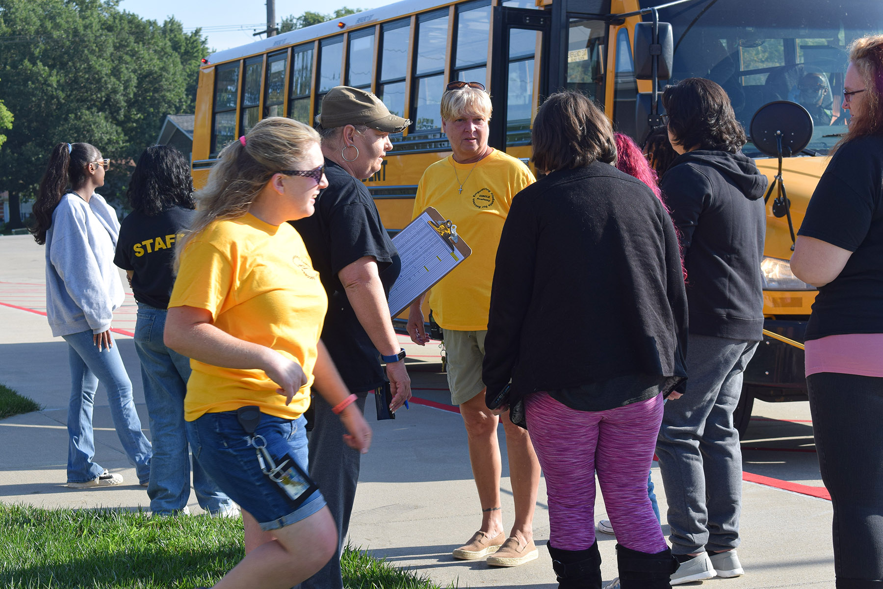staff and students arriving to school on bus