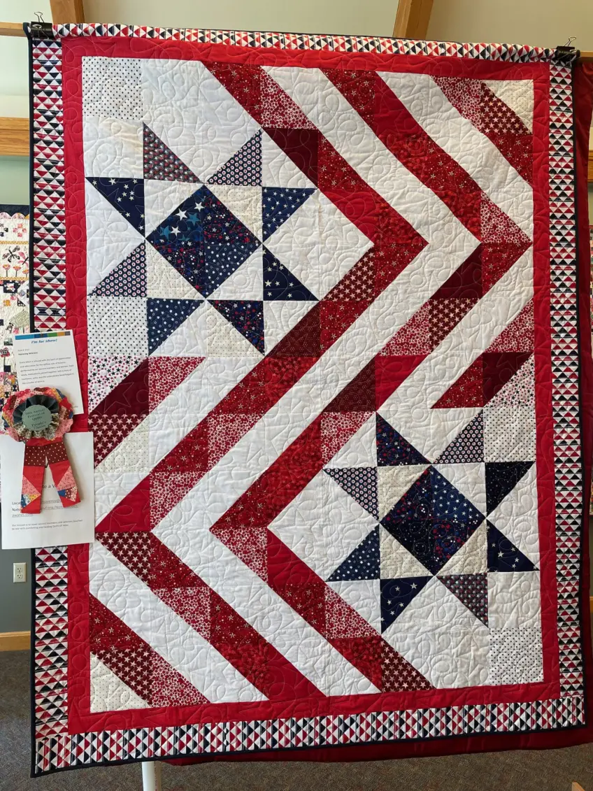 Patriotic quilt with red, white and blue border and stars and stripes interior