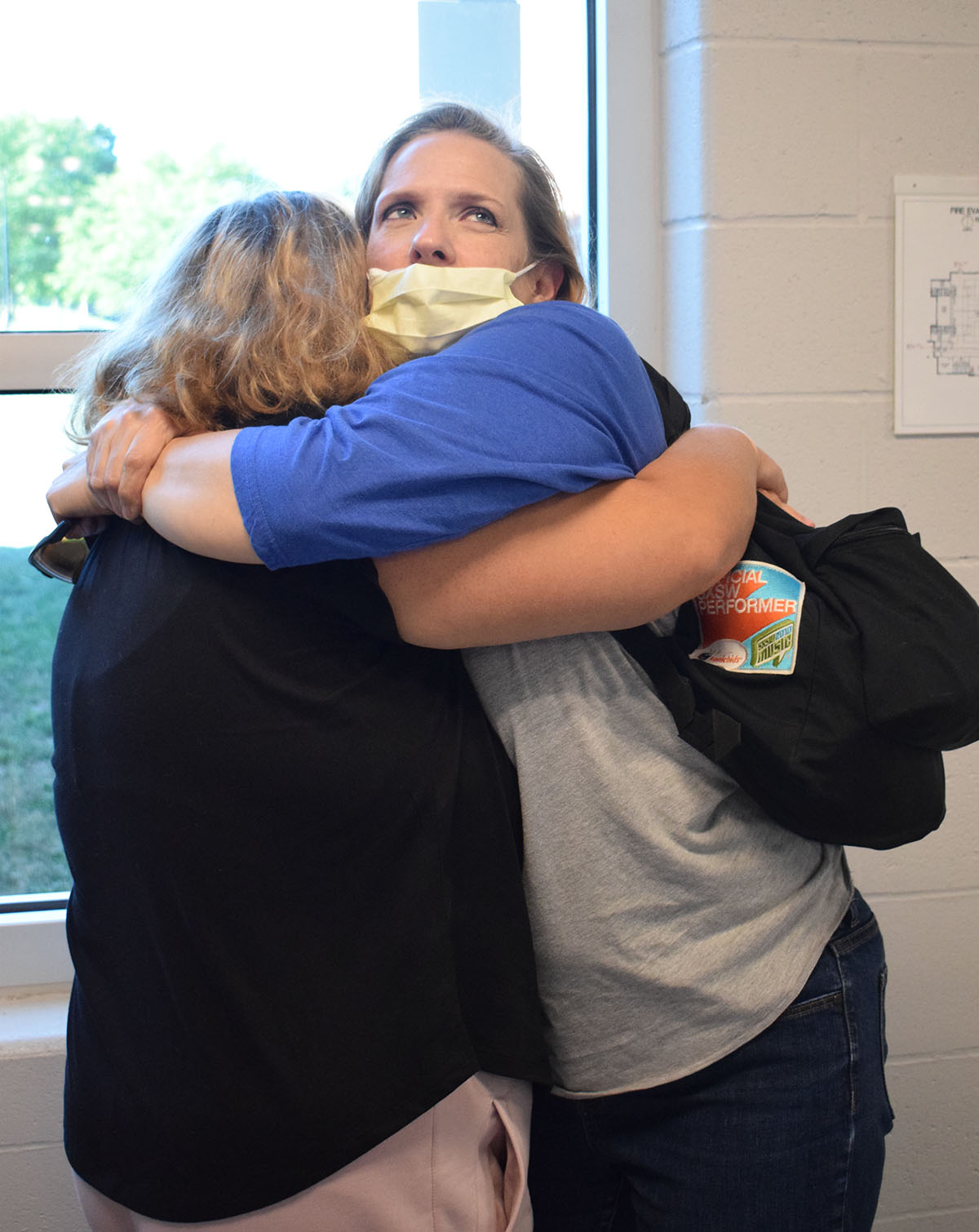 teacher assistant hugging student