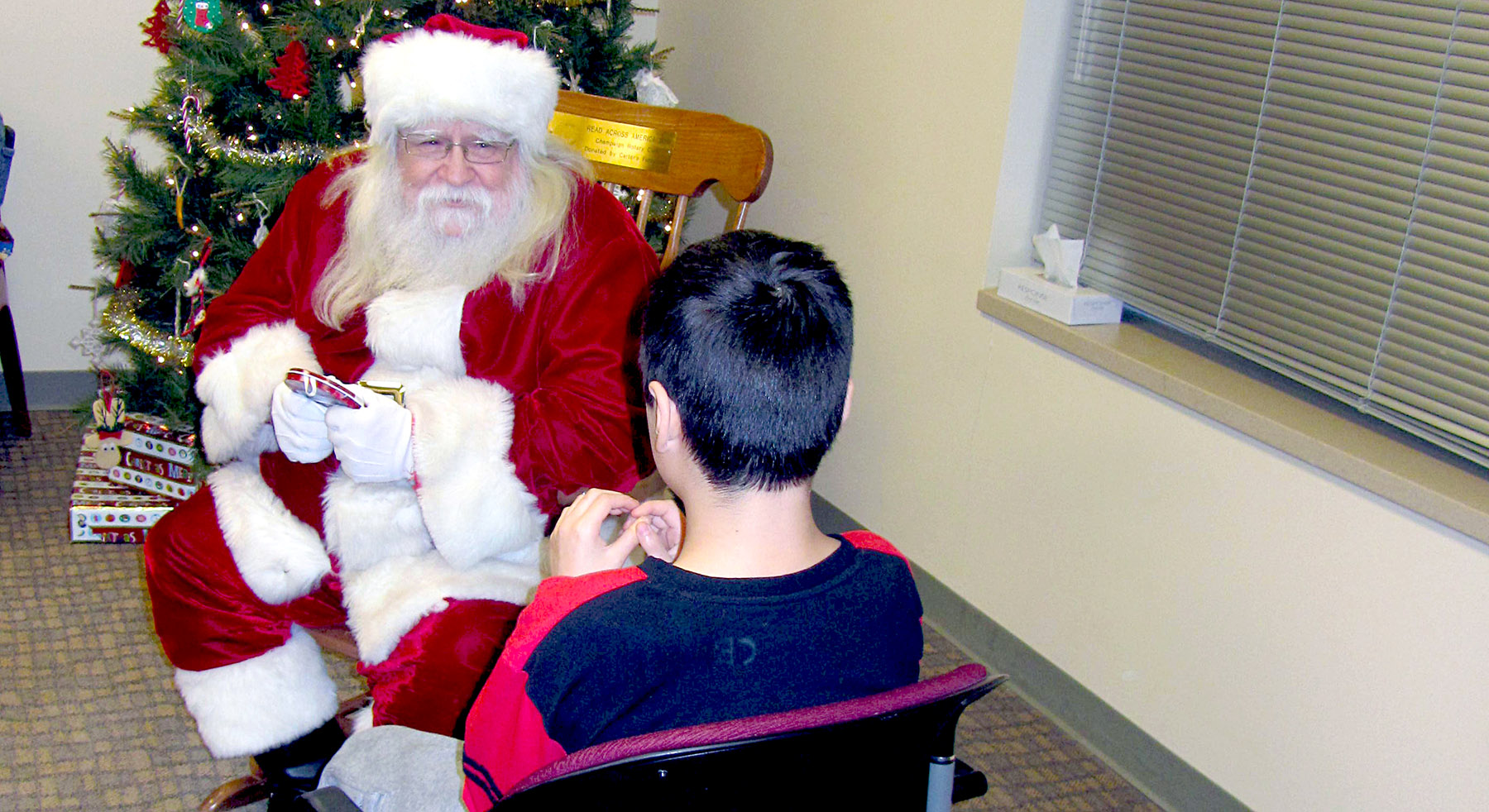 young boy siting down with Santa
