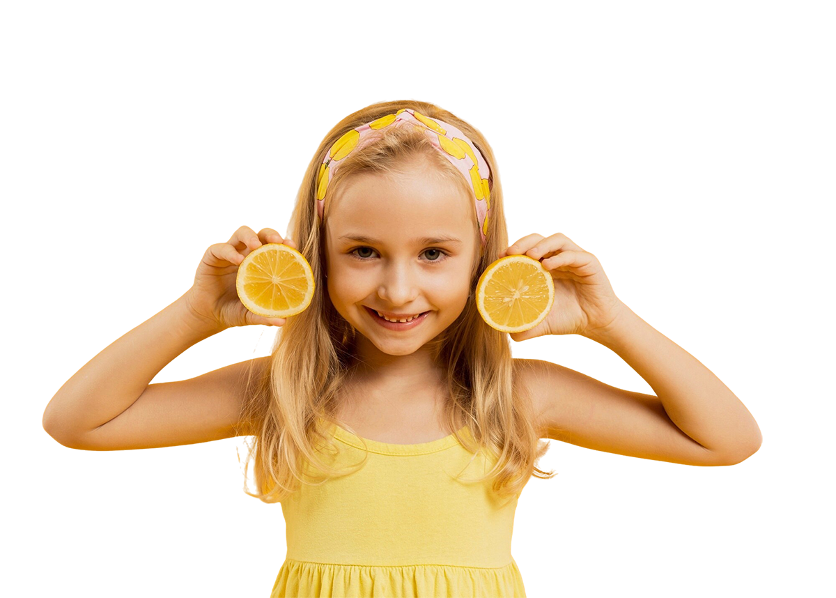 young girl with blond long hair in a yellow headband holding up cut in half lemons on either side of her face